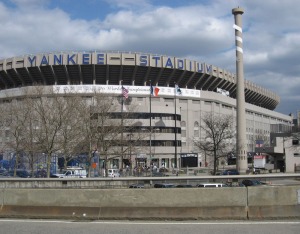 An exterior picture of the old Yankee Stadium in the Bronx, NY.  The famous "big bat" is visible.